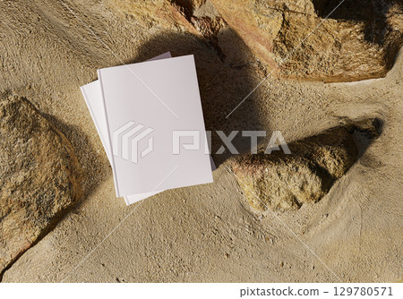 Book mockup on yellow sand with natural rocks outdoor background for design branding education storytelling creativity and inspirational concepts Book mockup on yellow sand with natural rocks outdoor background for design branding education storytelling creativity and inspirational concepts 129780571