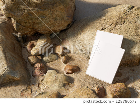 Book mockup on stone with golden sand background outdoor scene for design branding education storytelling creativity and natural concept Book mockup on stone with golden sand background outdoor scene for design branding education storytelling creativity and natural concept 129780572