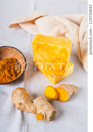 Organic Moisturizing Turmeric Soap Bars on Table vertical view 129780682
