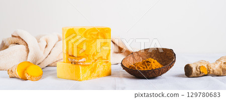 Natural homemade rejuvenating soap with turmeric on the table web banner 129780683