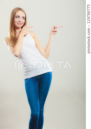 woman casual style pointing copy space text area 129780775
