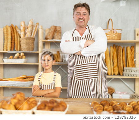 Father and little daughter - selling bread and various baguettes for sale Father and little daughter - selling bread and various baguettes for sale 129782320