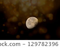 A captivating, textured image of the moon in a waxing gibbous phase 129782396