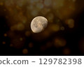 A captivating, textured image of the moon in a waxing gibbous phase 129782398