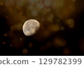 A captivating, textured image of the moon in a waxing gibbous phase 129782399