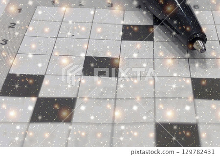 Sparkling Crossword Puzzle. A magical close-up of a crossword grid with a pencil. Perfect for themes of creativity, intelligence, and puzzles. Sparkling Crossword Puzzle. A magical close-up of a crossword grid with a pencil. Perfect for themes of creativity, intelligence, and puzzles. 129782431