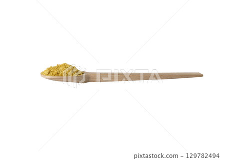 Savoury vegan yeast flakes on wooden spoon isolated on white background. Savoury vegan yeast flakes on wooden spoon isolated on white background. 129782494