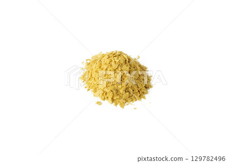 Savoury vegan yeast flakes heap isolated on white background. 129782496