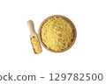 Savoury vegan yeast flakes in wooden bowl and scoop isolated on white background. 129782500