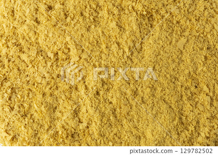 Savoury vegan yeast flakes background. 129782502