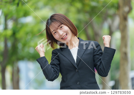 Young woman business outdoor fist pump 129783030