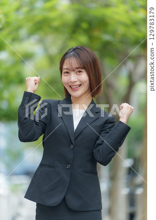 Young woman business outdoor fist pump Young woman business outdoor fist pump 129783179