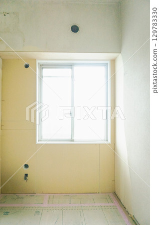 Interior renovation work in progress: Wall boards are being applied to the wallpaper in the western-style room on the north side of the apartment 129783330