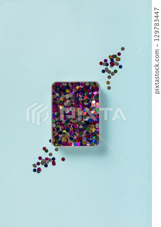 minimalist pastel blue background with confetti 129783447