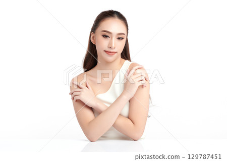 A beautiful young Asian woman with clean, fresh skin against a white background. Skincare, facial treatment, cosmetology, beauty, and spa. An elegant portrait of an Asian woman. A beautiful young Asian woman with clean, fresh skin against a white background. Skincare, facial treatment, cosmetology, beauty, and spa. An elegant portrait of an Asian woman. 129787451