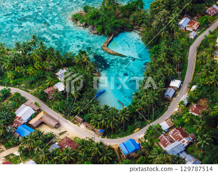 Sea coastline with lagoon and village with road in Indonesia. Aerial view Sea coastline with lagoon and village with road in Indonesia. Aerial view 129787514