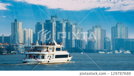 Elegant River Cruise Boat with Passengers Enjoying Scenic Shanghai Views Shanghai, China 129787680