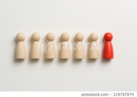 A red pawn at the end of a line of wooden pawns symbolizing leadership progression, guidance, and direction 129787874