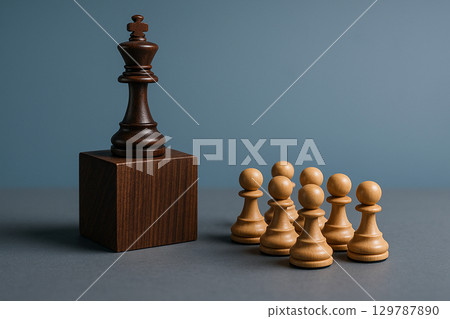 A king chess piece on a pedestal with pawns below representing authoritative leadership recognition A king chess piece on a pedestal with pawns below representing authoritative leadership recognition 129787890