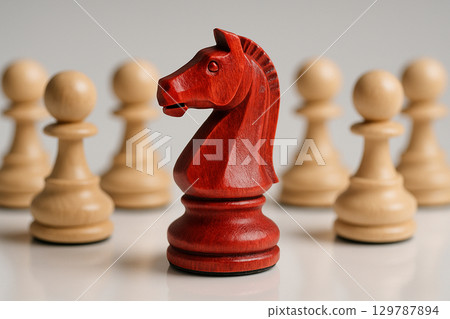 A dart red knight chess leading other white pawns to battle 129787894