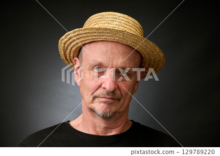 Portrait of a senior man in a vintage Harcourt style lighting 129789220