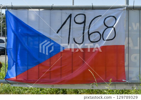 View of the Czech flag mounted on a railing. The flag shows the year 1968. On 20 21 August 1968, the Czechoslovak Socialist Republic was jointly invaded by four Warsaw Pact countries: the Soviet Union View of the Czech flag mounted on a railing. The flag shows the year 1968. On 20 21 August 1968, the Czechoslovak Socialist Republic was jointly invaded by four Warsaw Pact countries: the Soviet Union 129789329