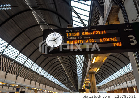 Train station platform with digital display showing train schedule to Madrid at Santa Justa train station in Seville, Spain Train station platform with digital display showing train schedule to Madrid at Santa Justa train station in Seville, Spain 129789551