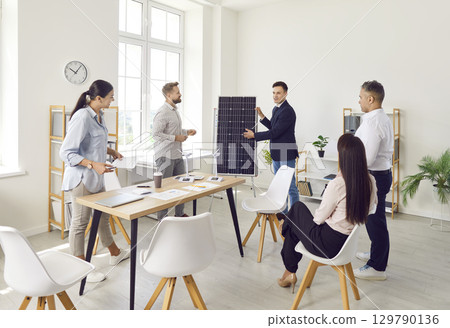 Businessman Consulting Team on Solar Panels in Office 129790136