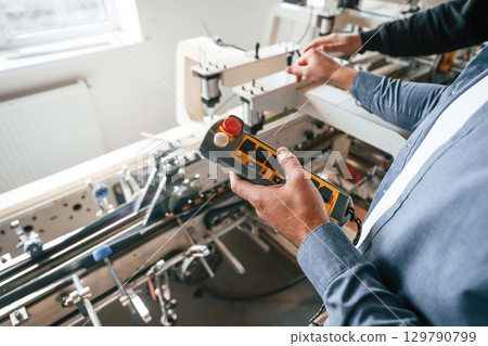 Technician is working. Handsome man is at the factory of creating eco boxes Technician is working. Handsome man is at the factory of creating eco boxes 129790799