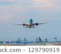 A blue aircraft taking off from Haneda Airport and ascending 129790919