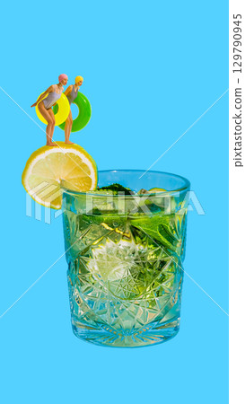 Creative collage. Two women with inflatable rings standing on lemon slice above mojito glass Creative collage. Two women with inflatable rings standing on lemon slice above mojito glass 129790945