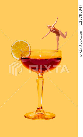 Contemporary collage. Woman balancing on cocktail glass with lemon slice and bright orange background 129790947