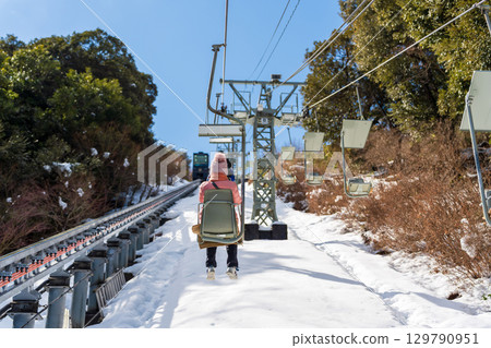 Tourists riding the lift at Amanohashidate View Land, snowy mountains in winter Tourists riding the lift at Amanohashidate View Land, snowy mountains in winter 129790951