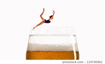Minimalist collage art. Diver mid-air above foamy beer glass with surreal energy Minimalist collage art. Diver mid-air above foamy beer glass with surreal energy 129790962