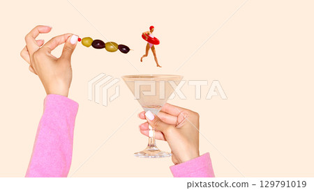 Surreal cocktail composition with olives skewer and miniature swimmer Surreal cocktail composition with olives skewer and miniature swimmer 129791019