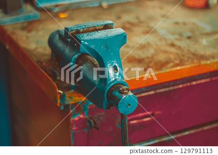 Metal bench vise in workshop Metal bench vise in workshop 129791113