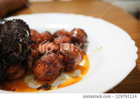 Spanish chorizo and blood sausage served on a white plate 129791114
