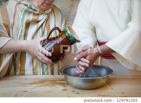 Woman pour water on hands Woman pour water on hands 129791205