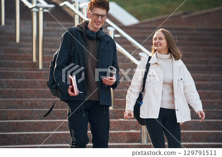 Having a break. Two young students are together outdoors 129791511