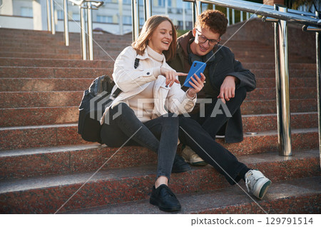 Having a break. Two young students are together outdoors 129791514