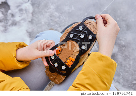 Rubber pad with ice grips for shoes are designed to provide better traction on icy surfaces. Rubber pad with ice grips for shoes are designed to provide better traction on icy surfaces. 129791741