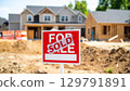 Sold sign in front of new homes under construction, showcasing vibrant real estate market. sign indicates successful sale amidst ongoing development 129791891