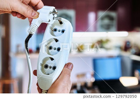 Homeowner plug too many heavy loads into light duty extension cord to burn down power cord tee. 129792050