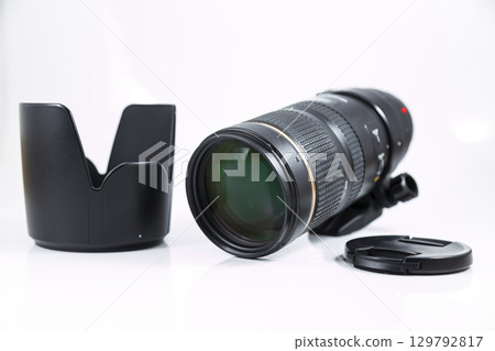 Black telephoto lens isolated on white background. 129792817