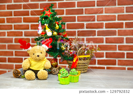 Christmas background with christmas tree for home decoration toy and teddy bear, snowman and cupcake in happy holiday concept. Christmas background with christmas tree for home decoration toy and teddy bear, snowman and cupcake in happy holiday concept. 129792832