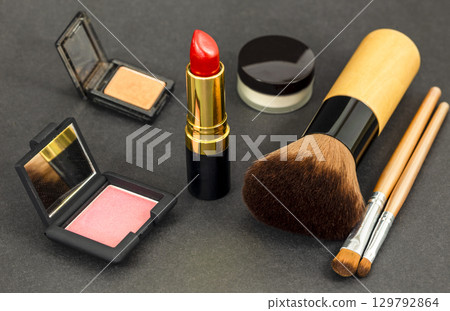 Set of decorative cosmetics, professional makeup tools brushes on black background. Set of decorative cosmetics, professional makeup tools brushes on black background. 129792864
