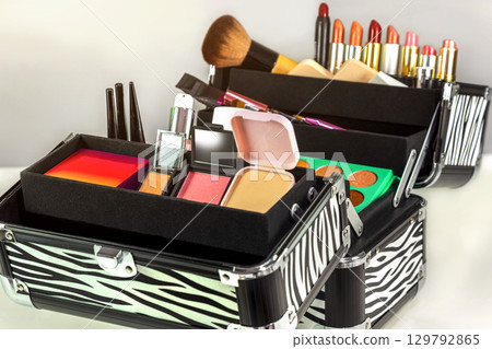 Make up case containing colorful eyeshadows, lipsticks, lip glosses, blushes and nail polishes 129792865