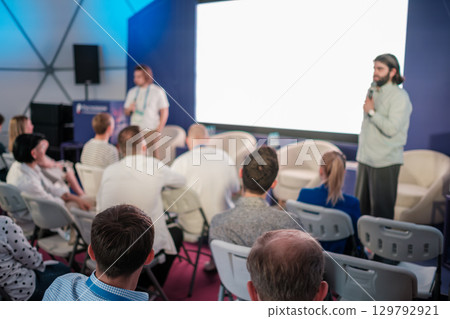 Speakers presenting to an attentive audience in a conference setting Speakers presenting to an attentive audience in a conference setting 129792921
