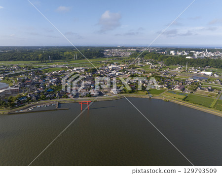 Aerial view of the first torii gate and townscape standing by the river 129793509