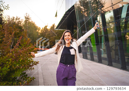 Smiling businesswoman feeling excited after finnshing work Smiling businesswoman feeling excited after finnshing work 129793634